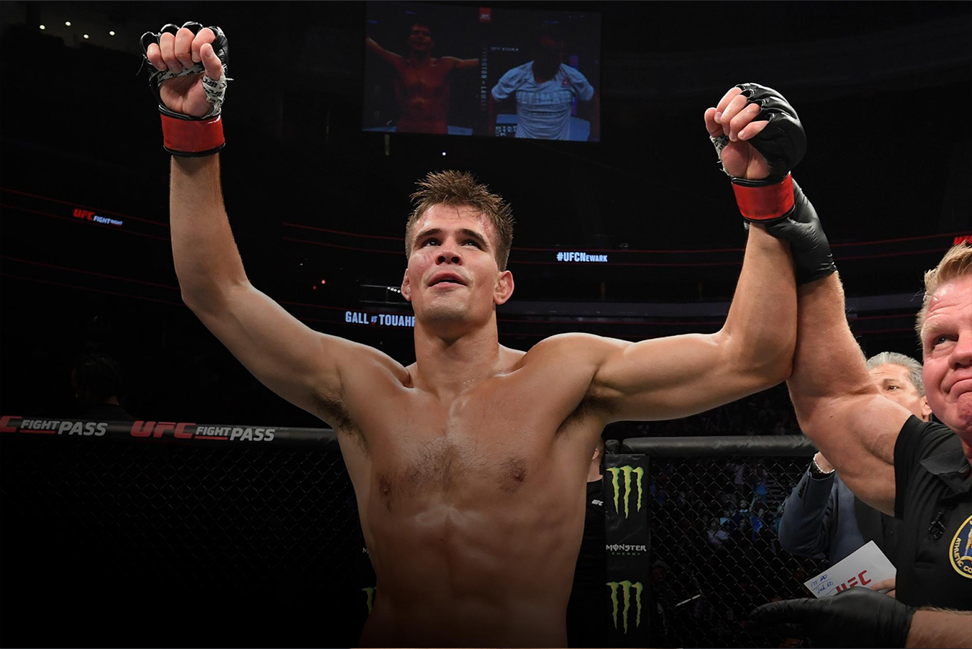 Mickey Gall raising his arms in victory inside the UFC octagon